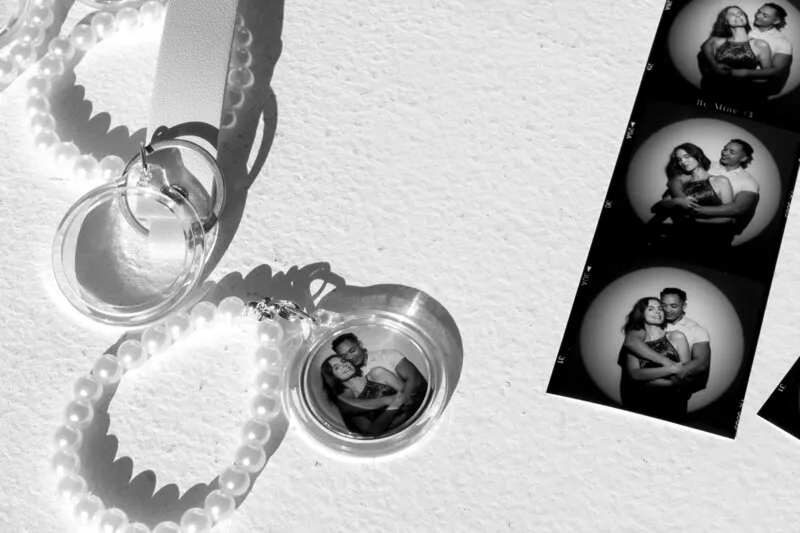 Heart-shaped photo keychains with pearl straps laid out on a white surface.