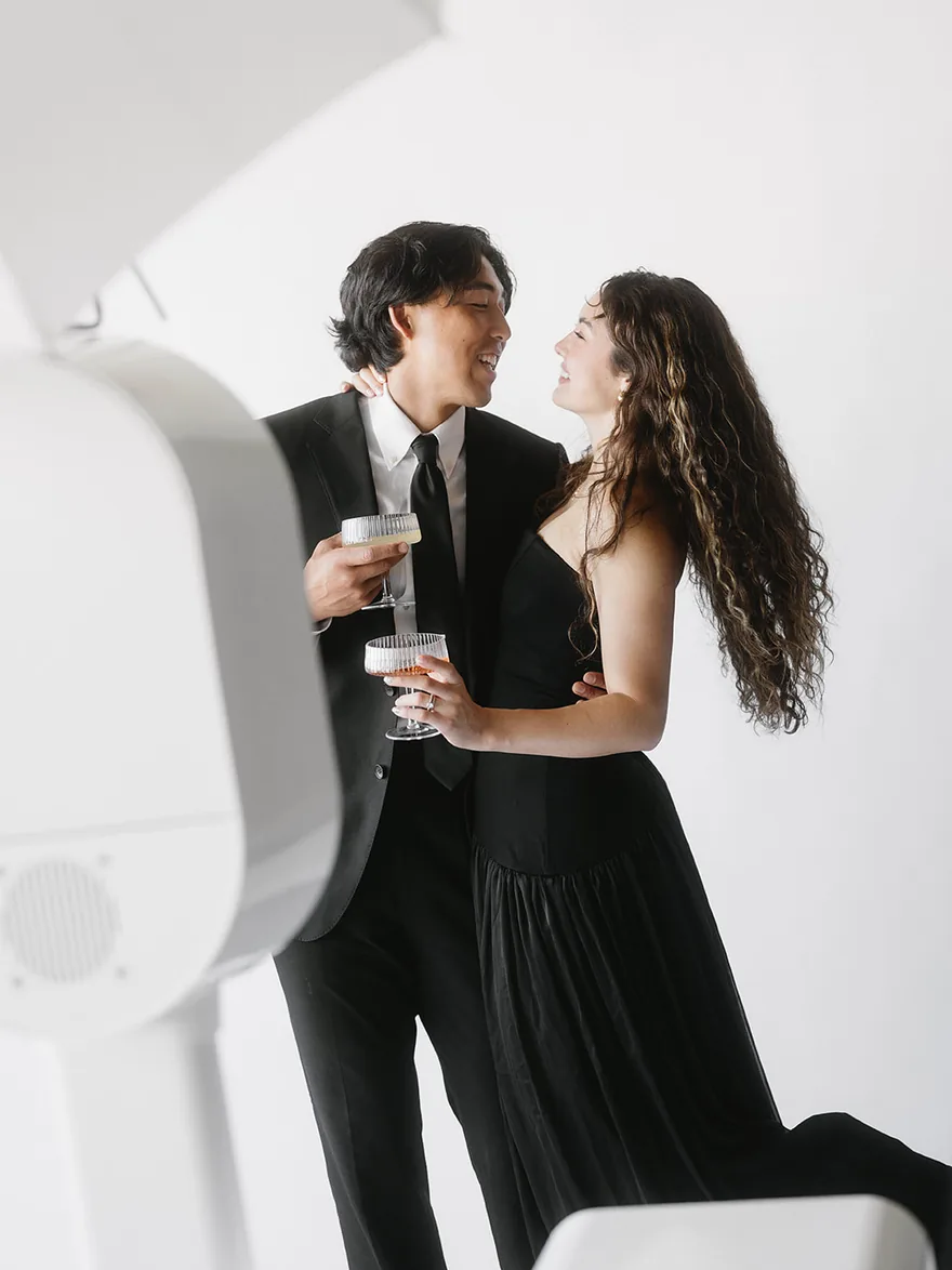 Couple toasting beside the photo booth